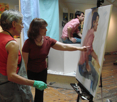 Luana instructing student at their easel.